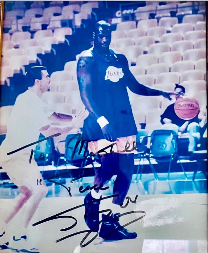 Signed photograph of Jim Cotta working with Shaquille O'Neal on the Lakers court
