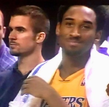 Jim Cotta beside Kobe Bryant on the Lakers sideline during the championship era, Kobe in a gold Lakers jersey with a towel over his shoulders